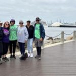 A group of people at the turnaround point of the walk overlooking the Queen Mary