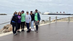 A group of people at the turnaround point of the walk overlooking the Queen Mary