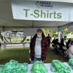 Chapter member Michael Thai handling the cool Walk4Hearing 2024 t-shirts