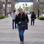 Fabiola standing outside the entrance to Cal State Fullerton