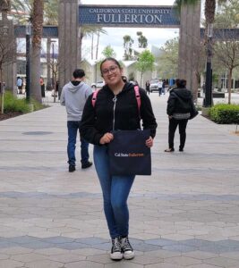 Fabiola standing outside the entrance to Cal State Fullerton