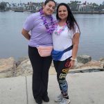 Fabiola posing with her mom in front of the marina