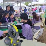 Face painters busy at their table.