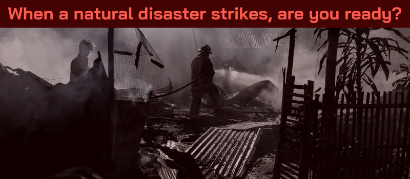 Fire scene of two firefighter looking over the damage after a fire.