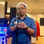 Chris on the microphone during the white elephant